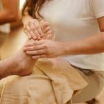 Close-up of a foot massage in a spa setting, highlighting relaxation and wellness.